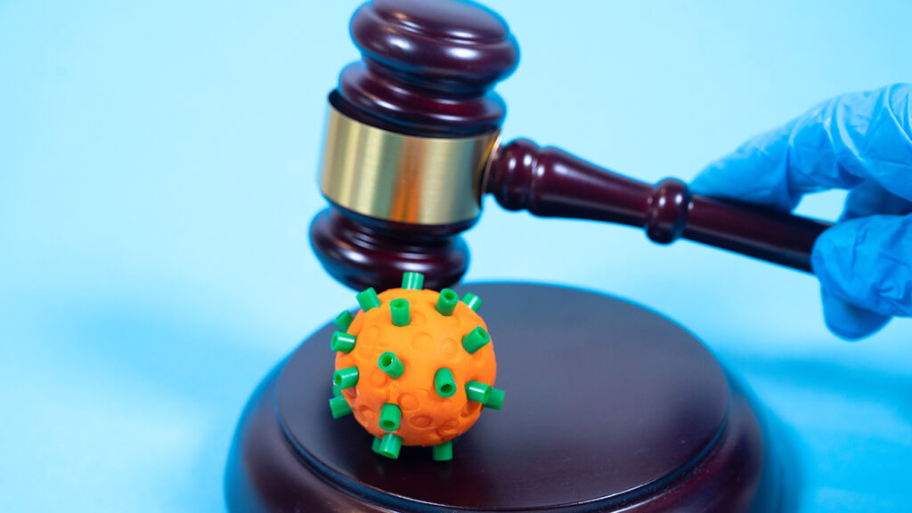 Judge's gavel and a COVID-19. Creative concept.