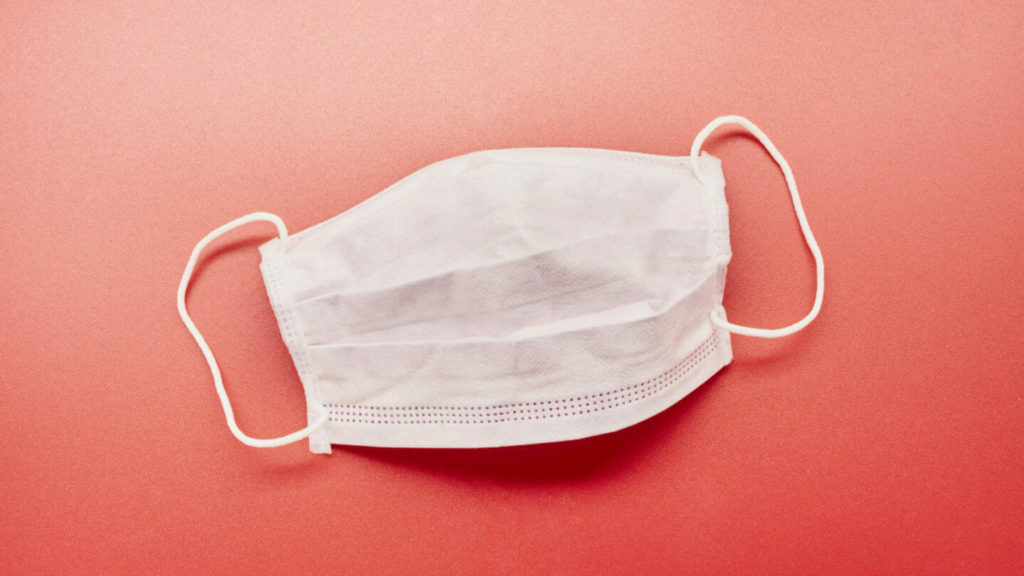 medical mask on orange background