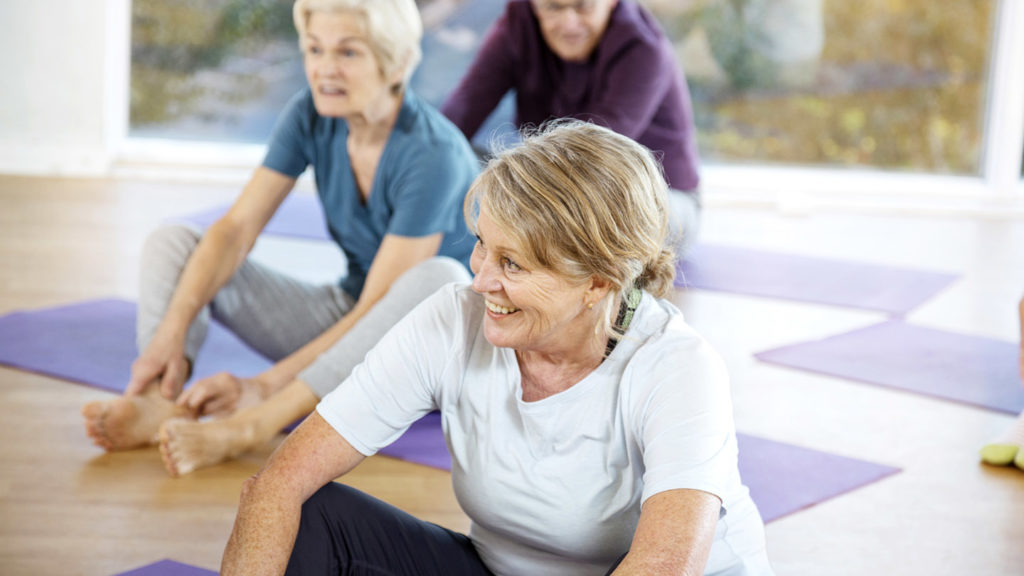 Group of seniors sitting in yoga class.