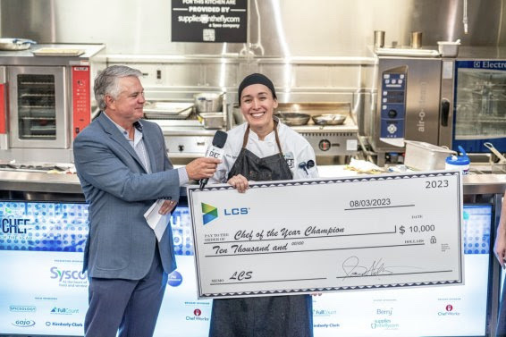 Kira Eggert poses with a big check