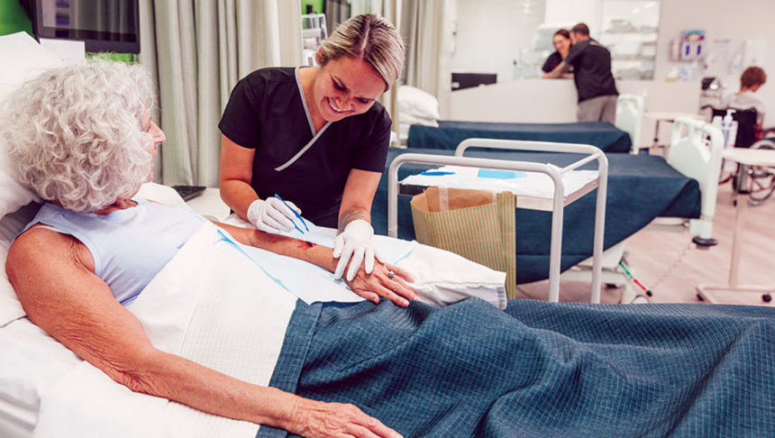 caregiver tending to a woman's wound