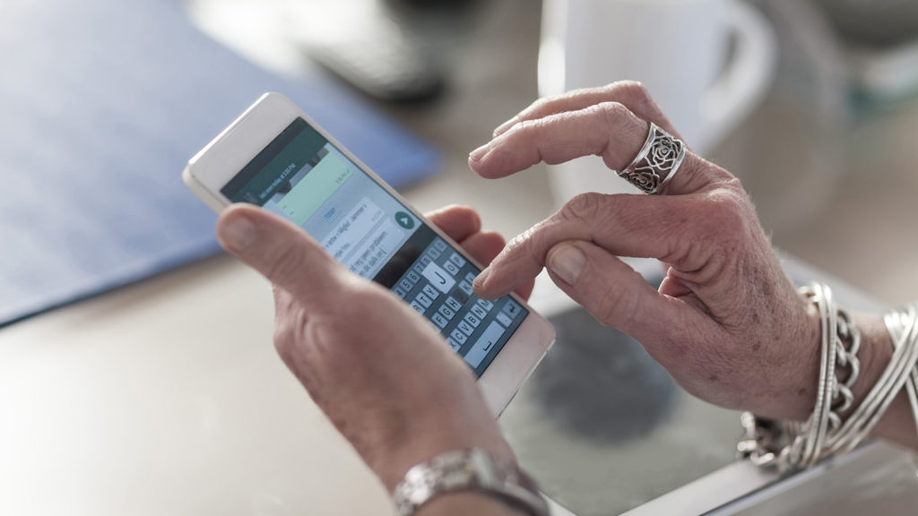 Closeup of woman texting on cell phone
