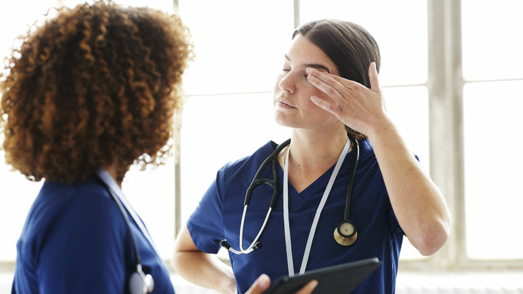 Two healthcare professionals in conversation